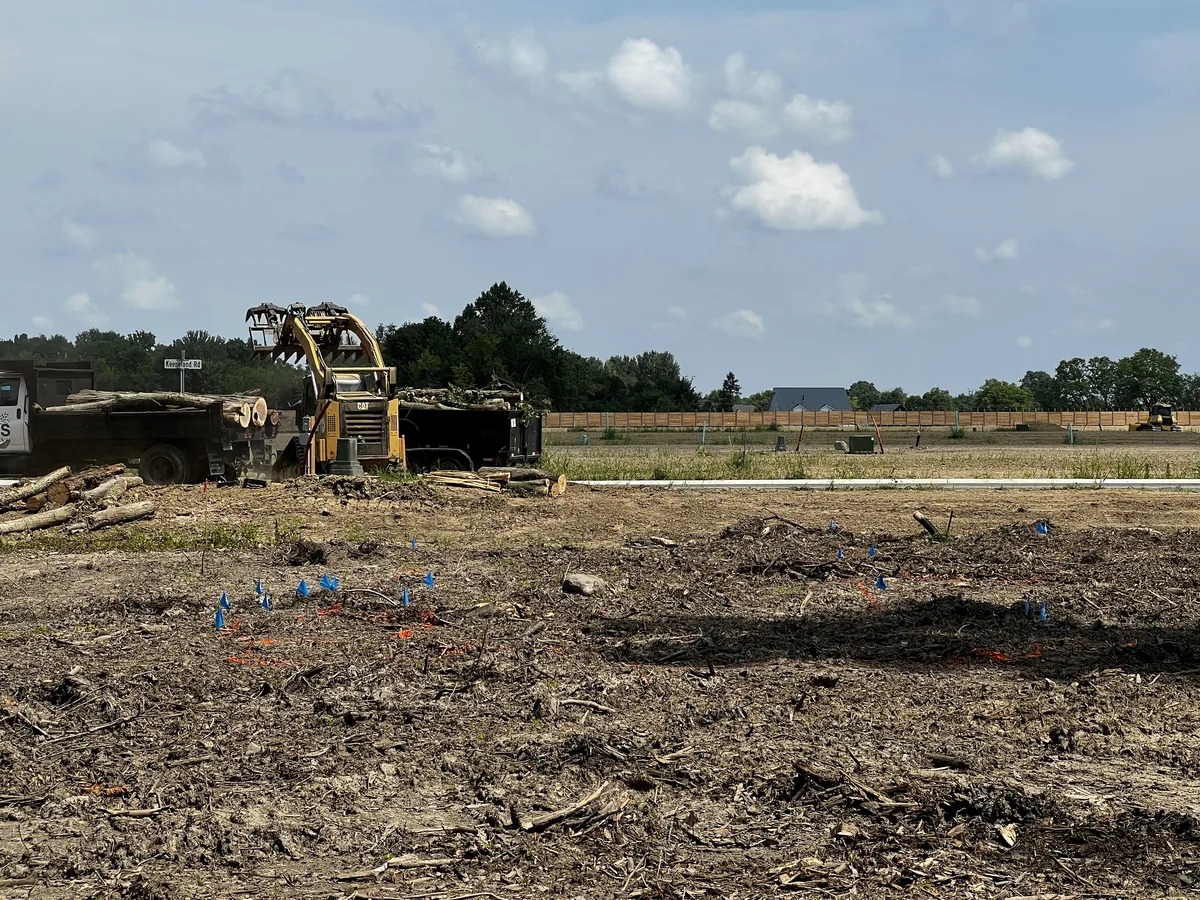 Heavy equipment clearing an open lot near Indianapolis