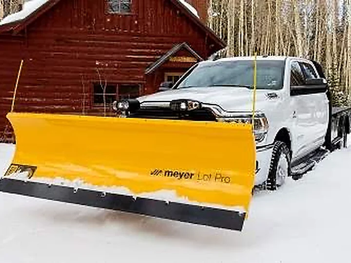 Truck fitted with a snow plow, ready for seasonal snow removal in Central Indiana